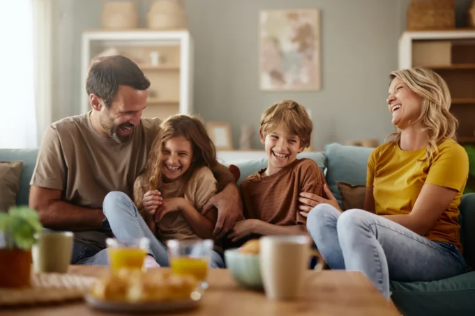 cheerful-parents-fun-kids-sofa-1001622576.webp.webp