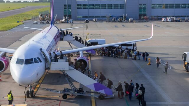 passengers-boarding-wizz-air-airplane-1037574823.jpg