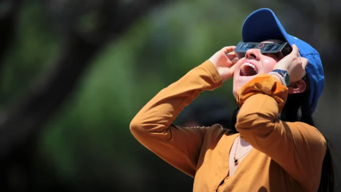surprised-woman-observes-total-solar-eclipse-april-2024.webp