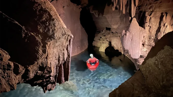 researcher-in-flooded-cave-grand-canyon.webp